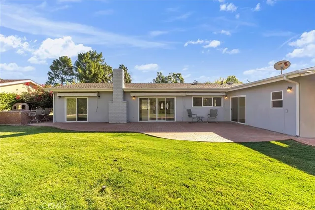 a view of a house with swimming pool and a yard