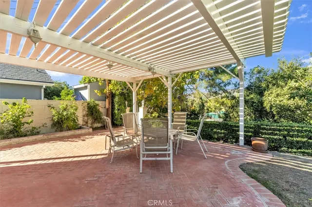 a view of a patio with table and chairs and potted plants