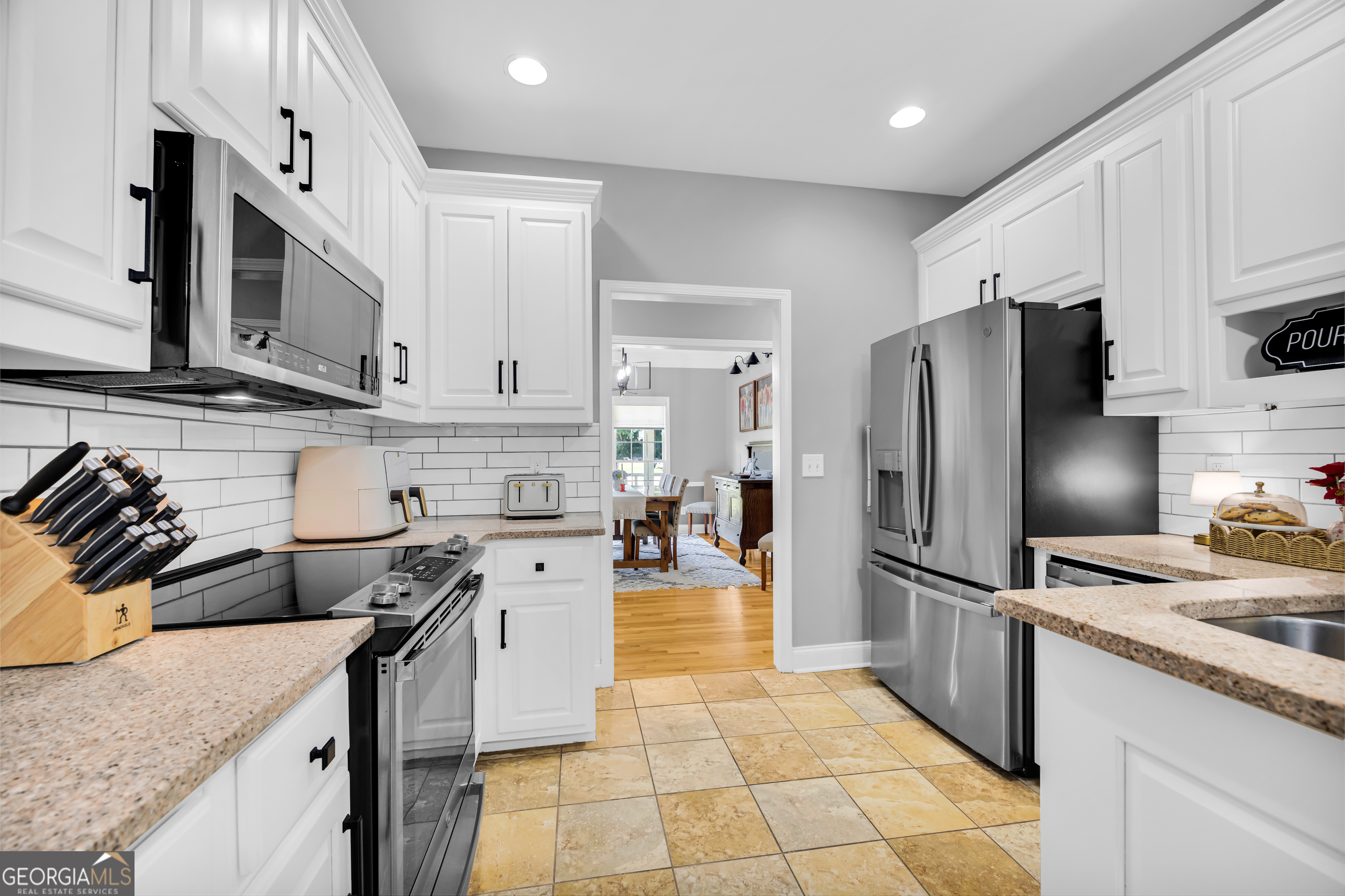 533 Emory Chambers Road Lula, GA 30554 - Photo 26 of 88 a kitchen with stainless steel appliances granite countertop a refrigerator stove and sink