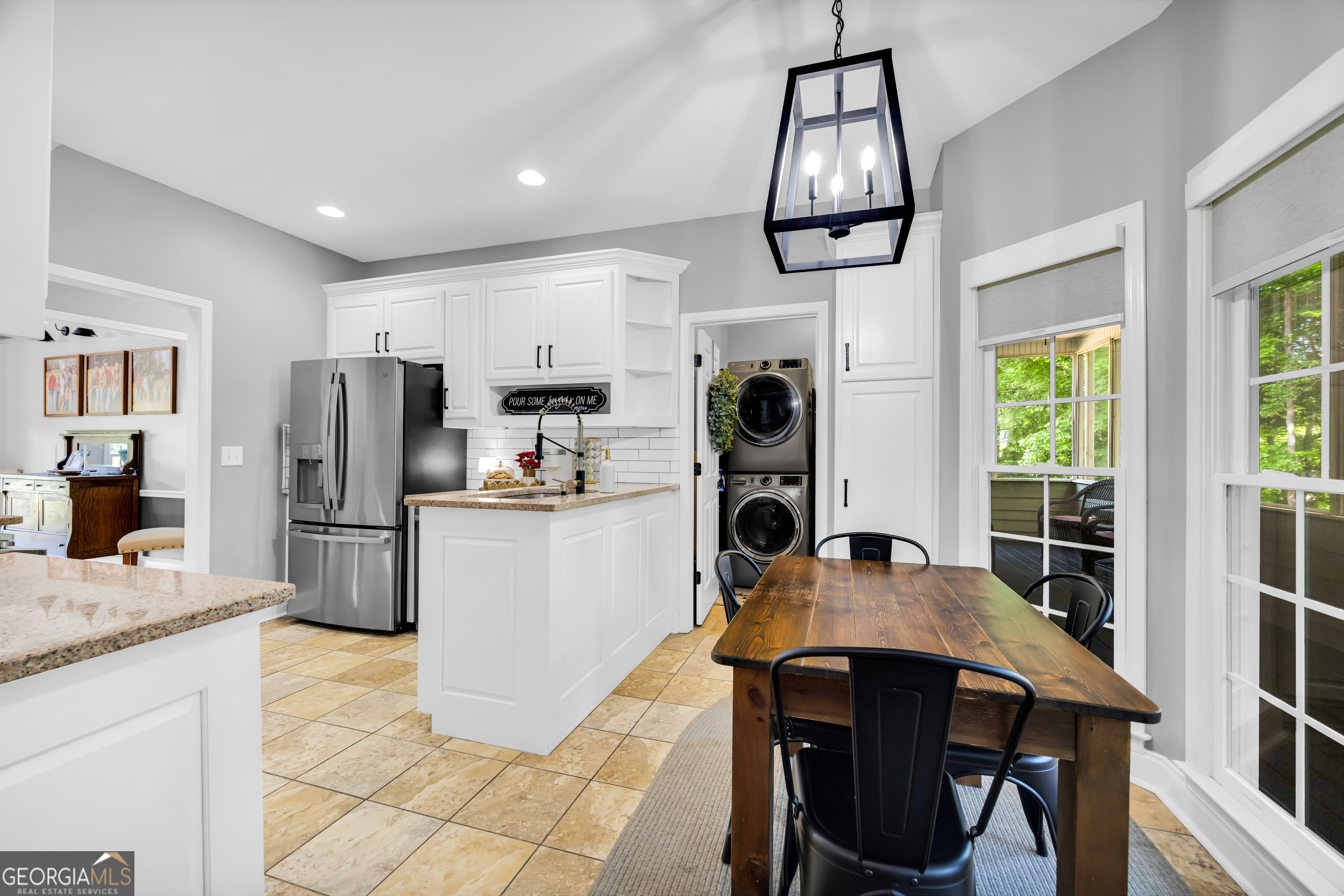 533 Emory Chambers Road Lula, GA 30554 - Photo 29 of 88 a kitchen with stainless steel appliances granite countertop a stove a refrigerator a sink a dining table and chairs with wooden floor