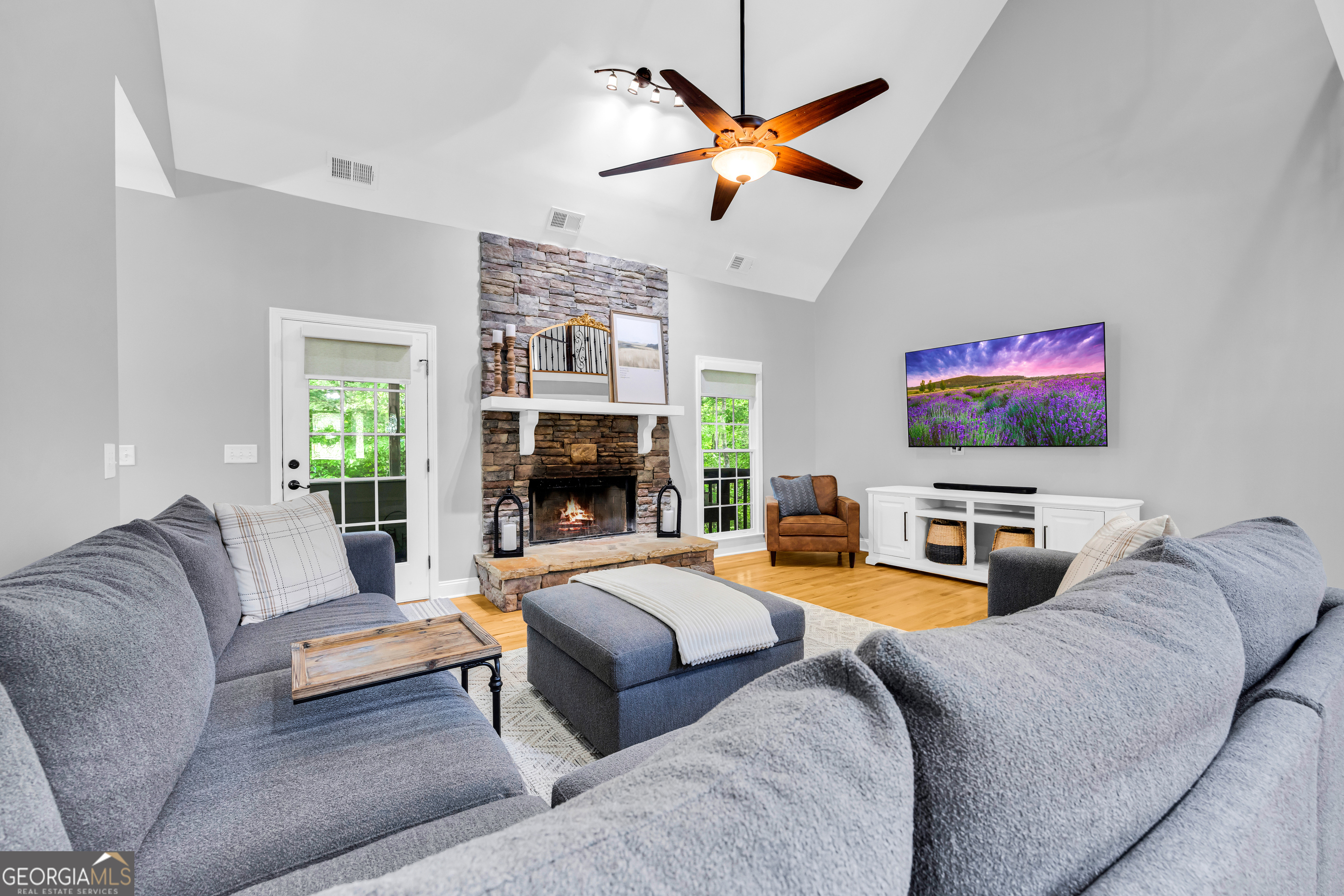 533 Emory Chambers Road Lula, GA 30554 - Photo 33 of 88 a living room with furniture a fireplace and a flat screen tv