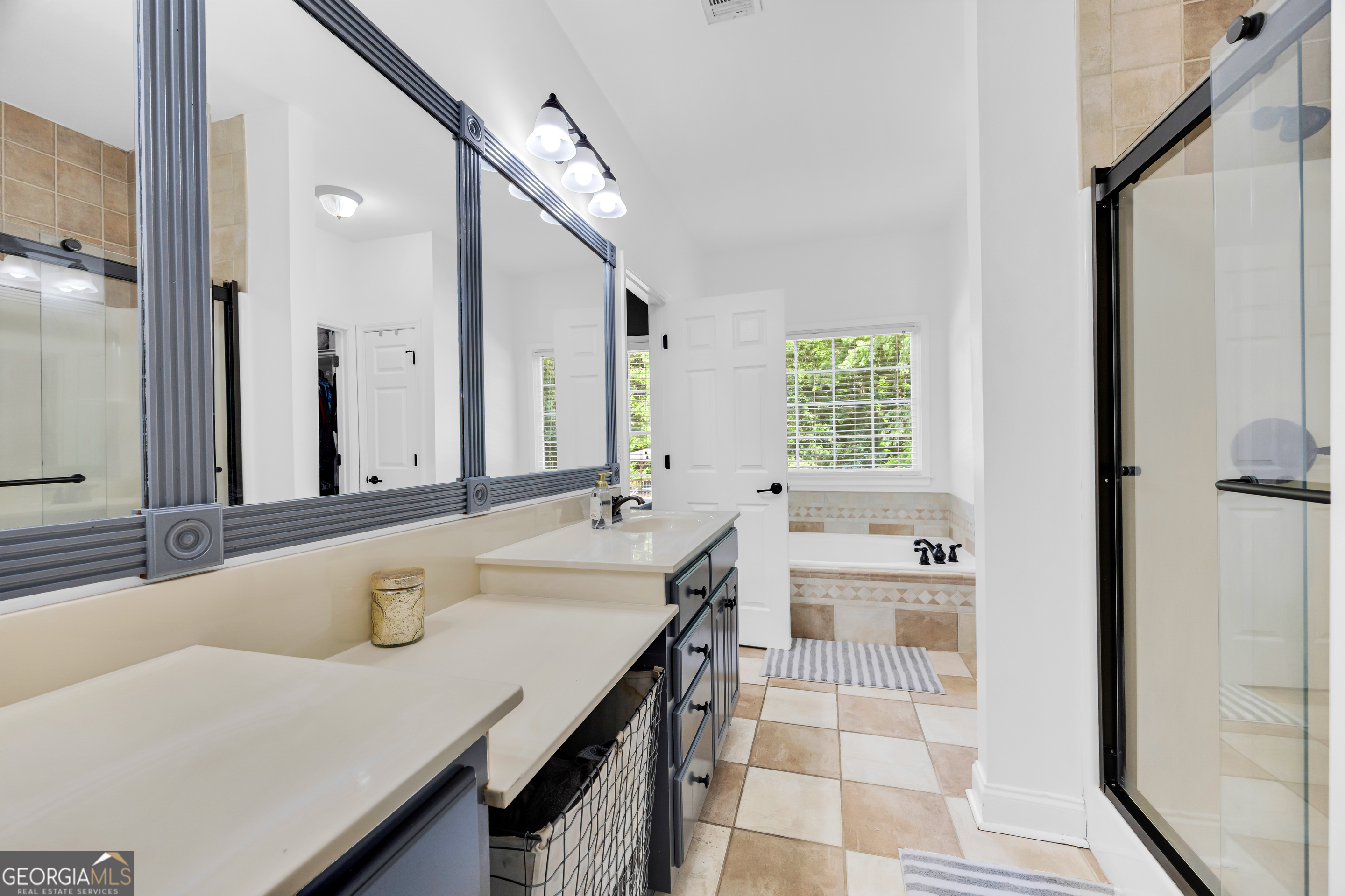 533 Emory Chambers Road Lula, GA 30554 - Photo 42 of 88 a bathroom with a tub sink and mirror