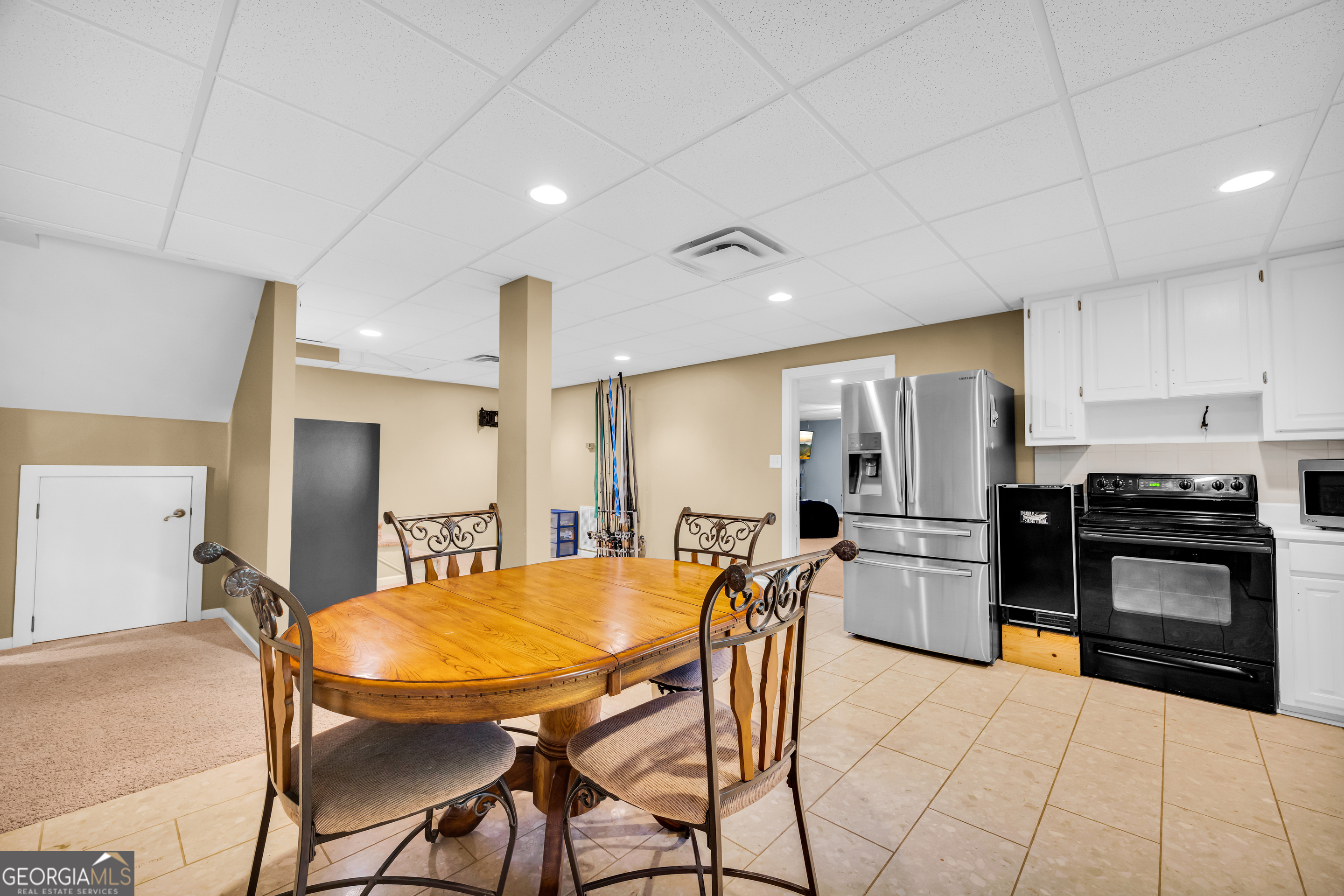 533 Emory Chambers Road Lula, GA 30554 - Photo 64 of 88 a kitchen with stainless steel appliances kitchen island granite countertop a refrigerator a stove a sink a dining table and chairs with wooden floor