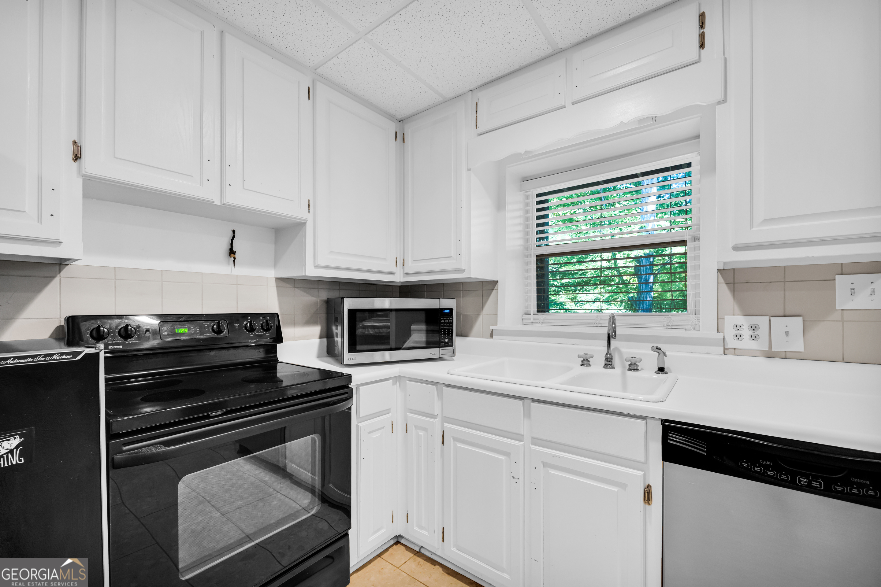533 Emory Chambers Road Lula, GA 30554 - Photo 66 of 88 a kitchen with cabinets appliances a sink and a window
