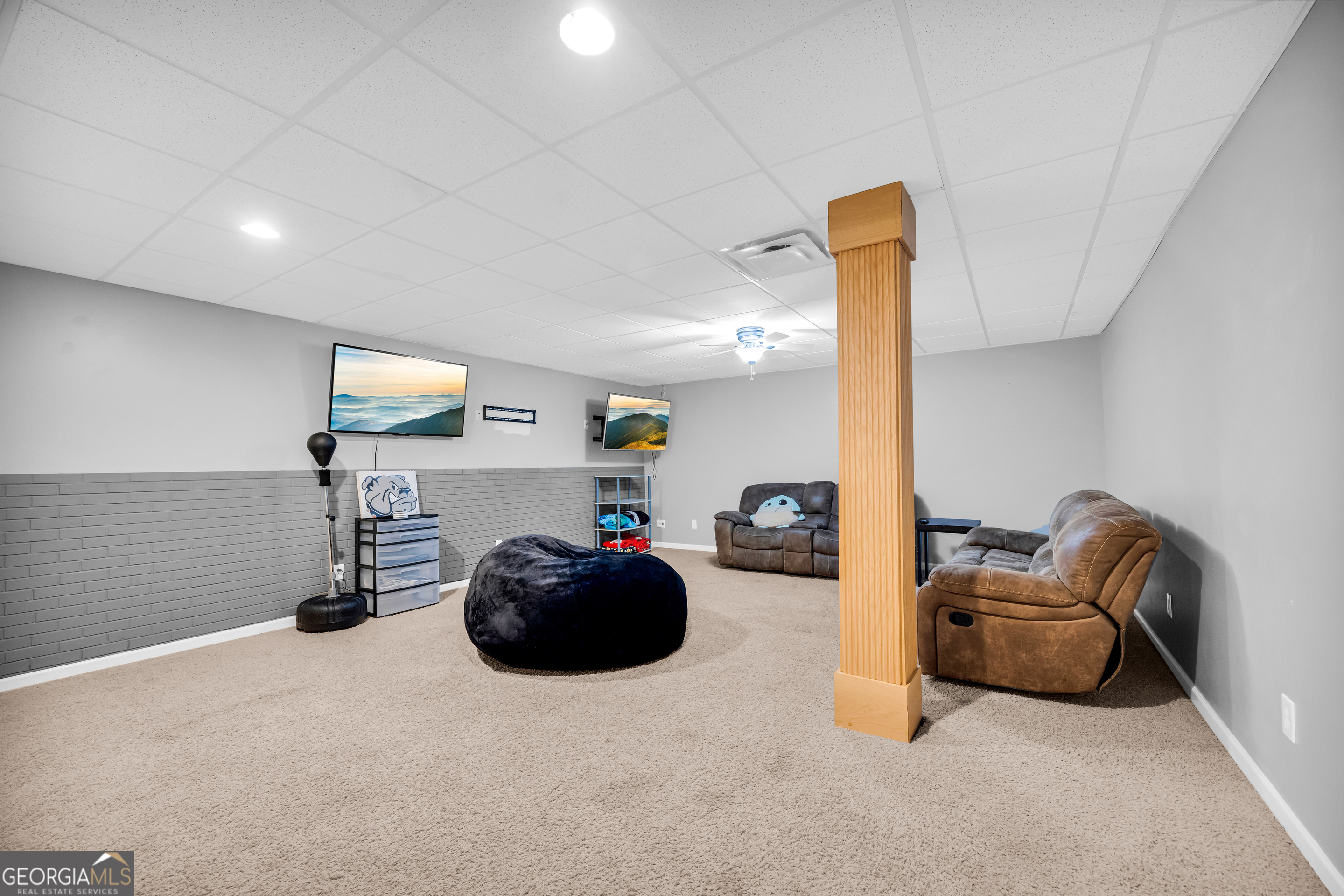 533 Emory Chambers Road Lula, GA 30554 - Photo 81 of 88 a living room with furniture a flat screen tv and gym equipment