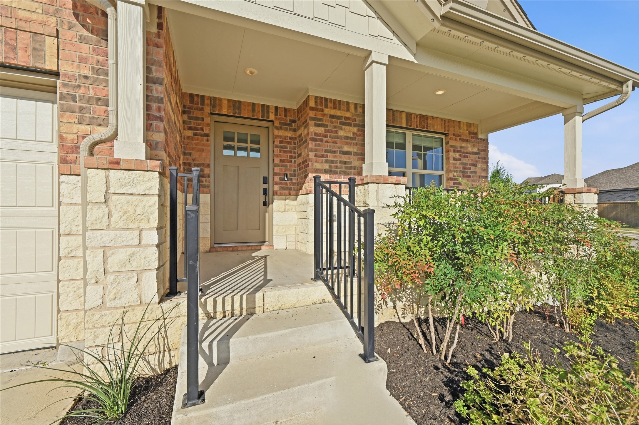 426 Cold Riv Run Kyle, TX 78640 - Photo 6 of 34 A welcoming entry featuring brick and stone masonry, with a neat landscaping bed enhancing the curb appeal.