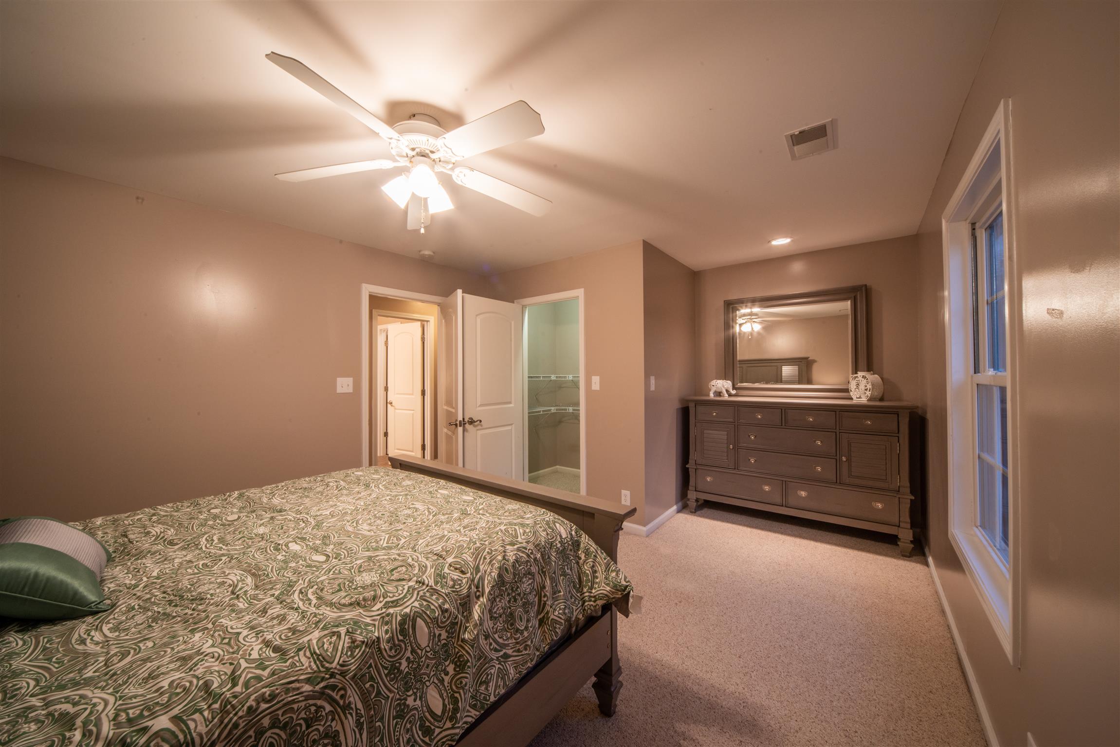 2945 Old Clarksville Springfield Road Adams, TN 37010 - Photo 22 of 30 a bedroom with a bed and a ceiling fan