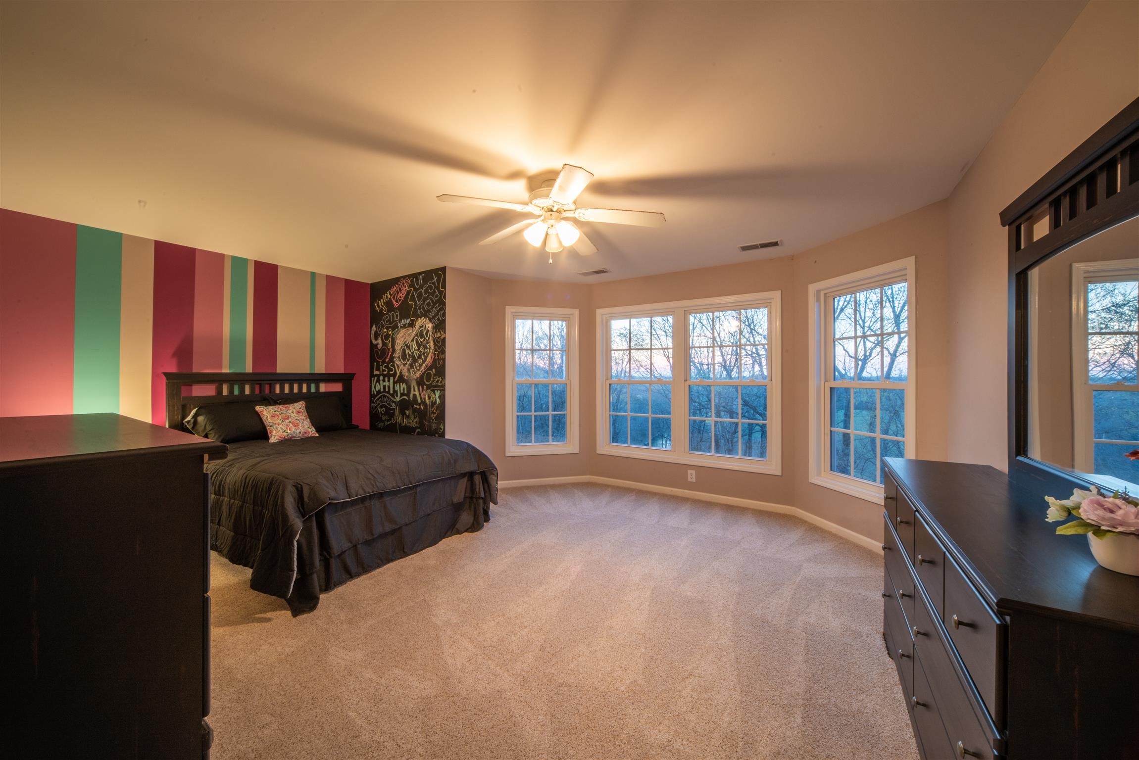 2945 Old Clarksville Springfield Road Adams, TN 37010 - Photo 24 of 30 a spacious bedroom with a large bed and a chandelier