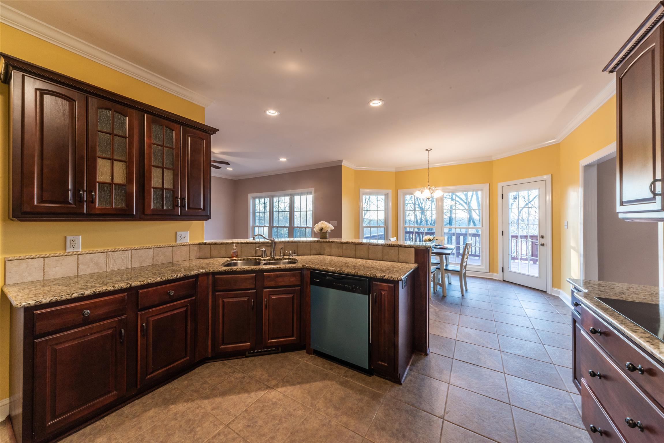 2945 Old Clarksville Springfield Road Adams, TN 37010 - Photo 10 of 30 a large kitchen with kitchen island granite countertop a sink and dishwasher wooden cabinets with granite countertops