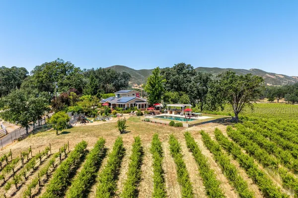 an aerial view of a house with yard