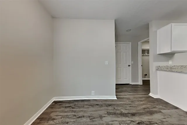 a view of a utility room with closet and wooden floor