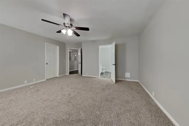 a view of empty room with ceiling fan