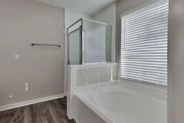 a bathroom with a tub and a shower