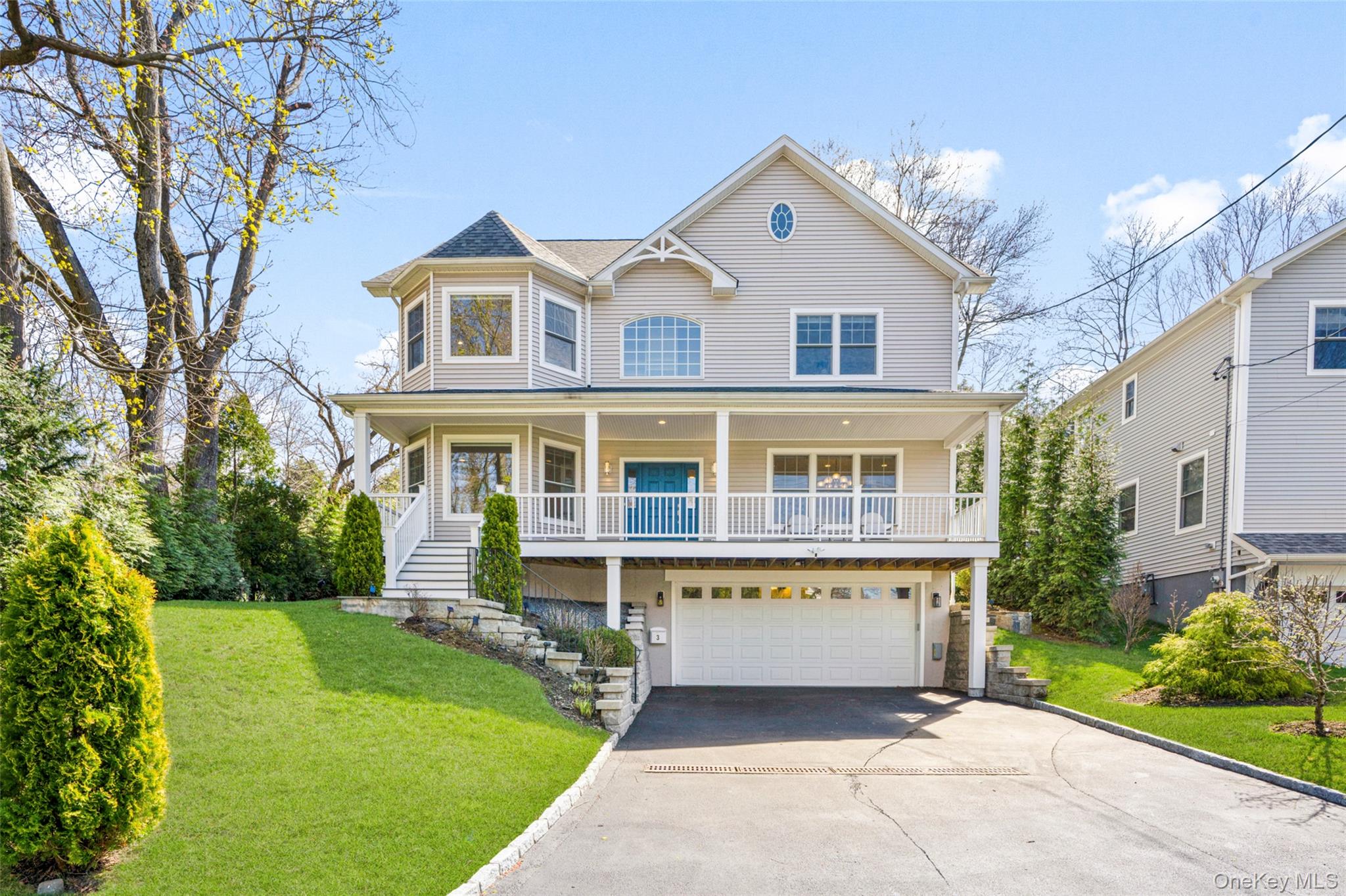 a view of a white house with a big yard and large trees