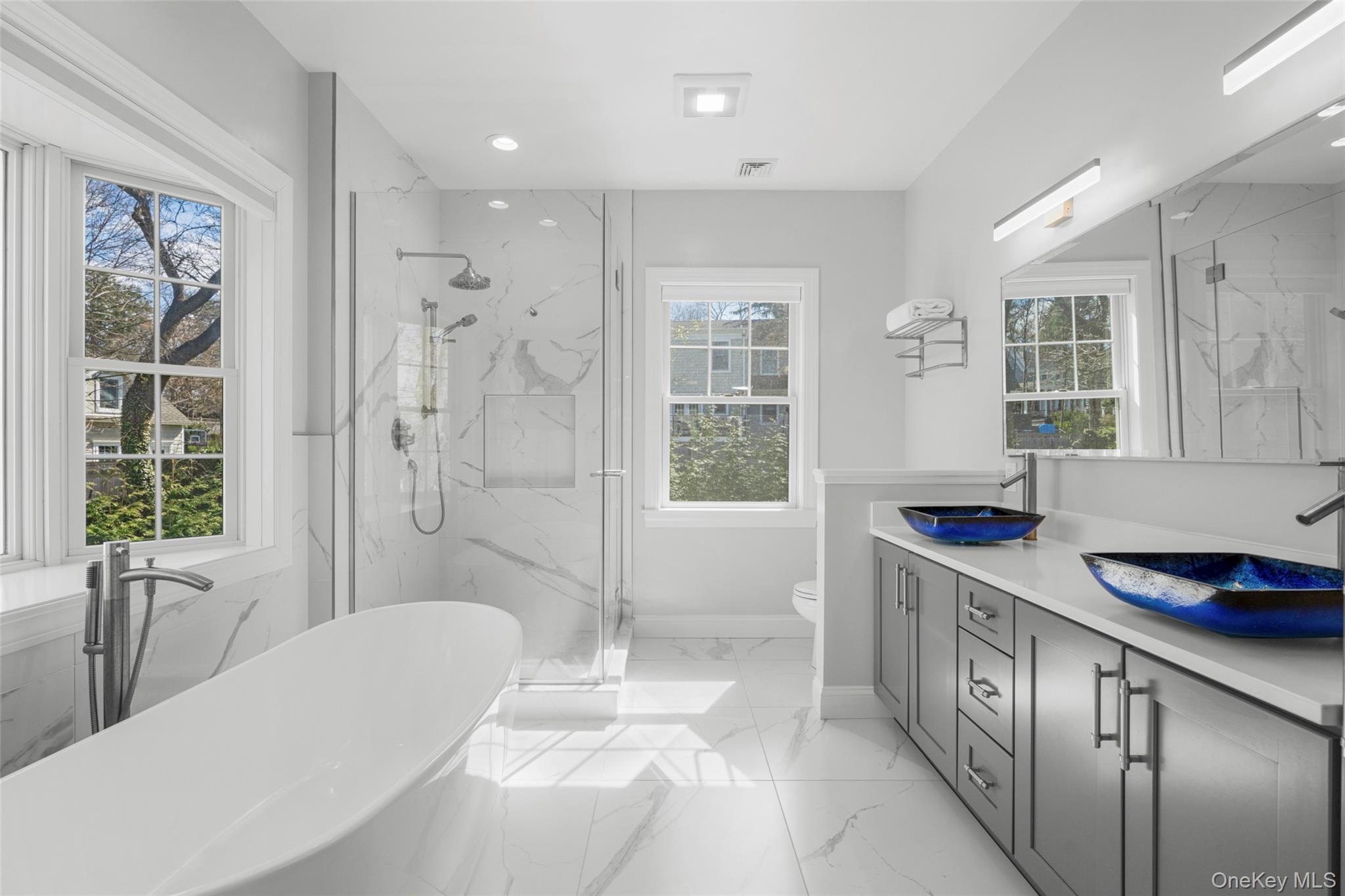 3 Robin Hill Road Scarsdale, NY 10583 - Photo 15 of 32 a bathroom with a tub sink and shower