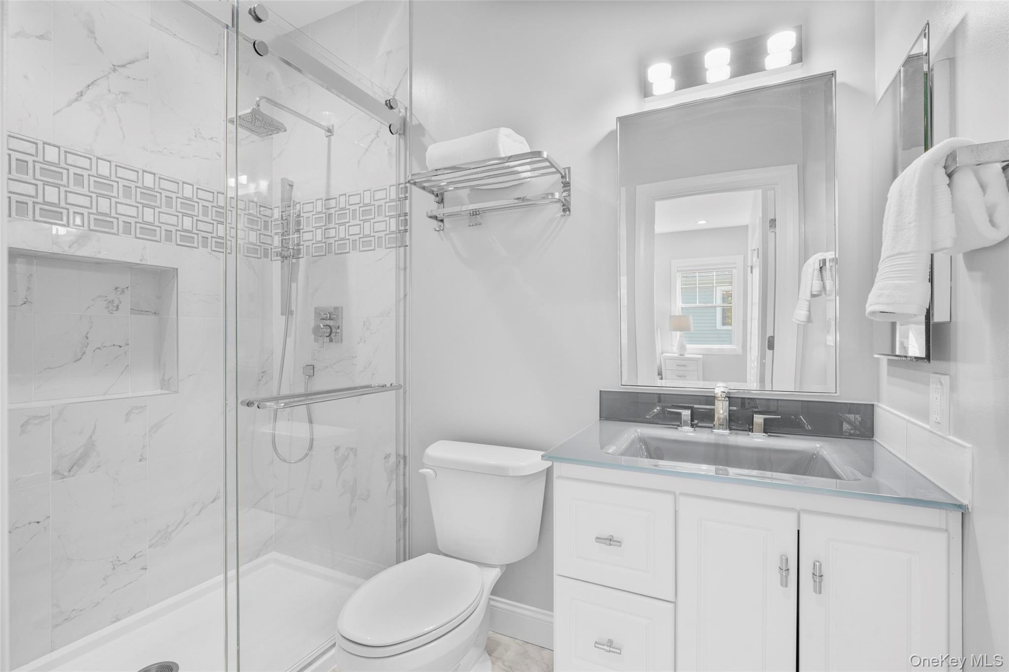 3 Robin Hill Road Scarsdale, NY 10583 - Photo 20 of 32 a bathroom with a granite countertop sink toilet a mirror and shower