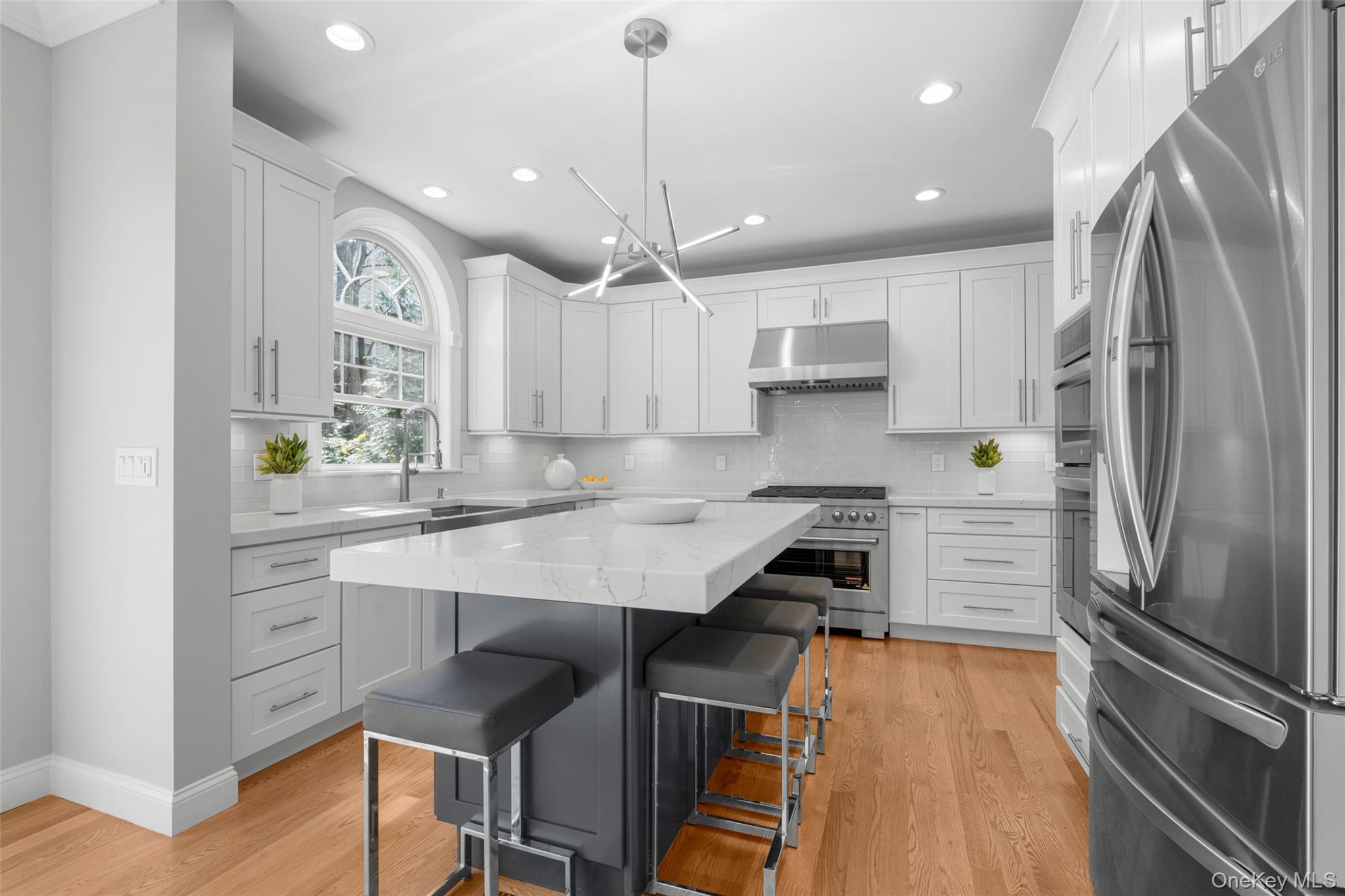 3 Robin Hill Road Scarsdale, NY 10583 - Photo 6 of 32 a kitchen with a refrigerator a sink and cabinets