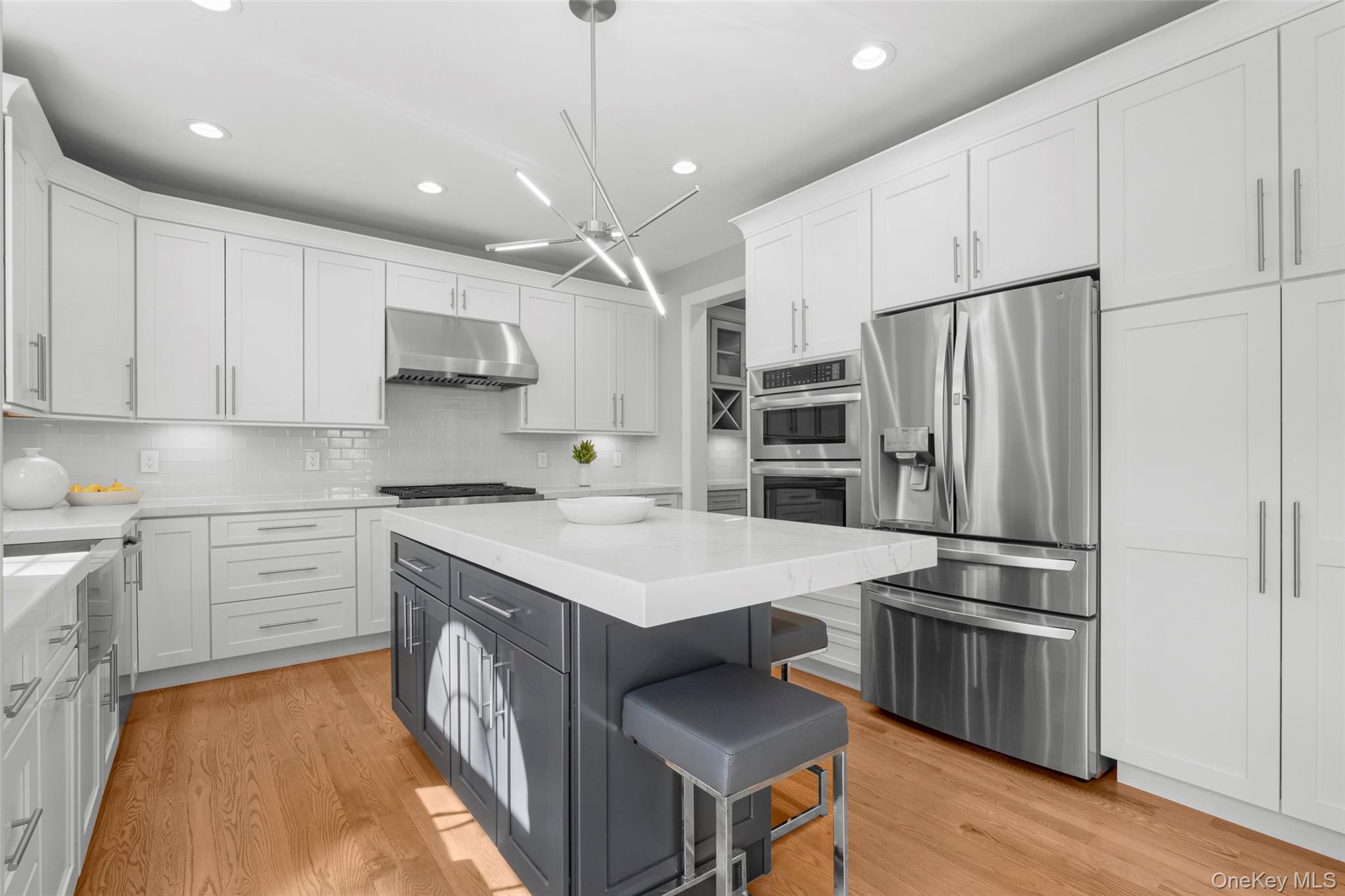 3 Robin Hill Road Scarsdale, NY 10583 - Photo 7 of 32 a kitchen with kitchen island a sink stainless steel appliances and cabinets