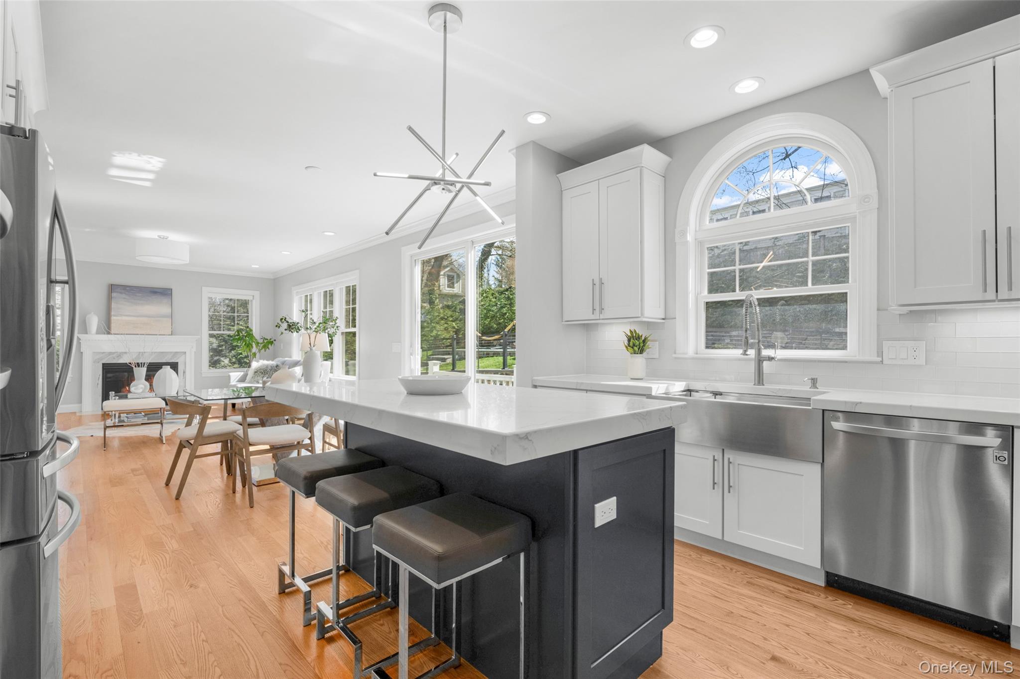 3 Robin Hill Road Scarsdale, NY 10583 - Photo 8 of 32 a open kitchen with stainless steel appliances granite countertop a stove a refrigerator a sink dishwasher a dining table and chairs with wooden floor