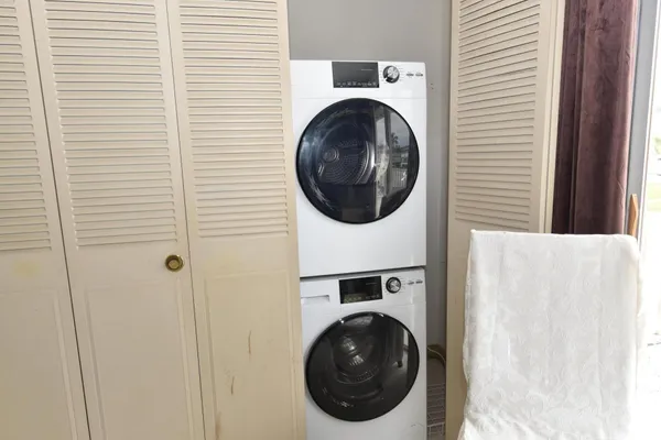 a view of a hallway with washer and dryer