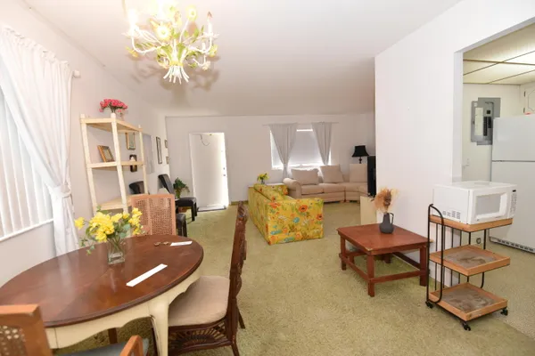 a living room with furniture and a chandelier