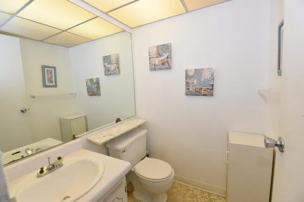 a bathroom with a sink mirror and toilet
