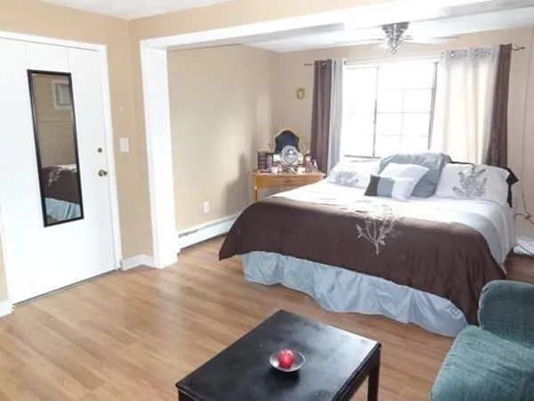 a bedroom with a bed and window