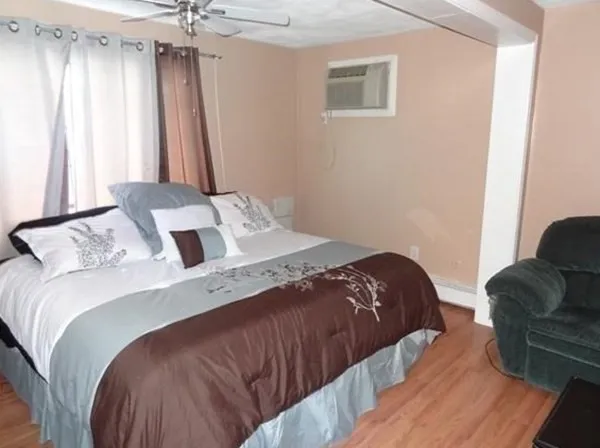 a bedroom with a bed and a couch