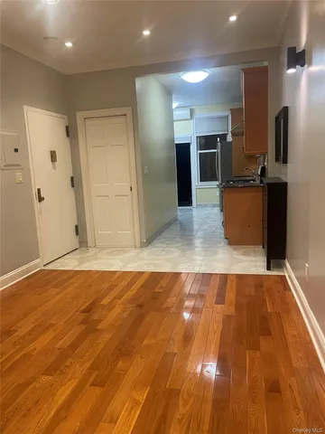 a view of kitchen with refrigerator microwave and wooden floor