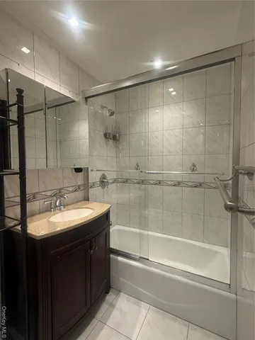 a bathroom with a sink double vanity and shower