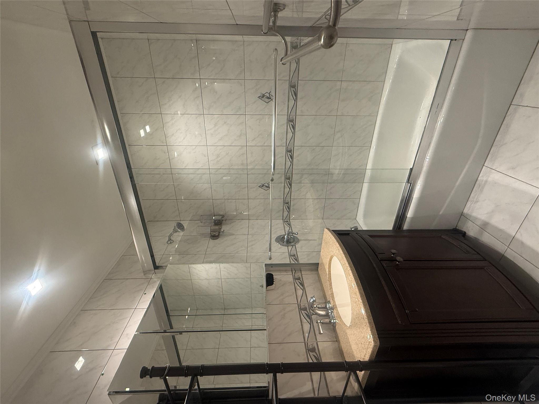 72-31 68th Street Queens, NY 11385 - Photo 7 of 7 a bathroom with a sink double vanity and shower