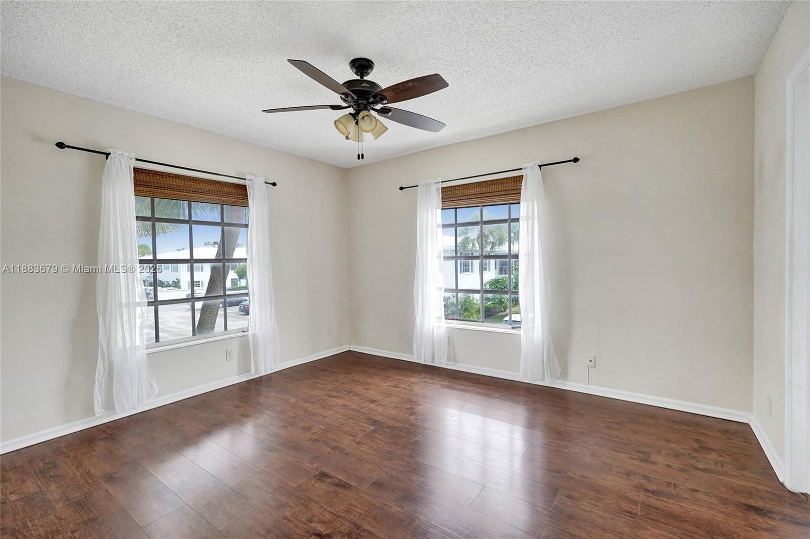 2181 Northeast 67th Street, Unit 622 Fort Lauderdale, FL 33308 - Photo 11 of 28 a view of an empty room with wooden floor and a window
