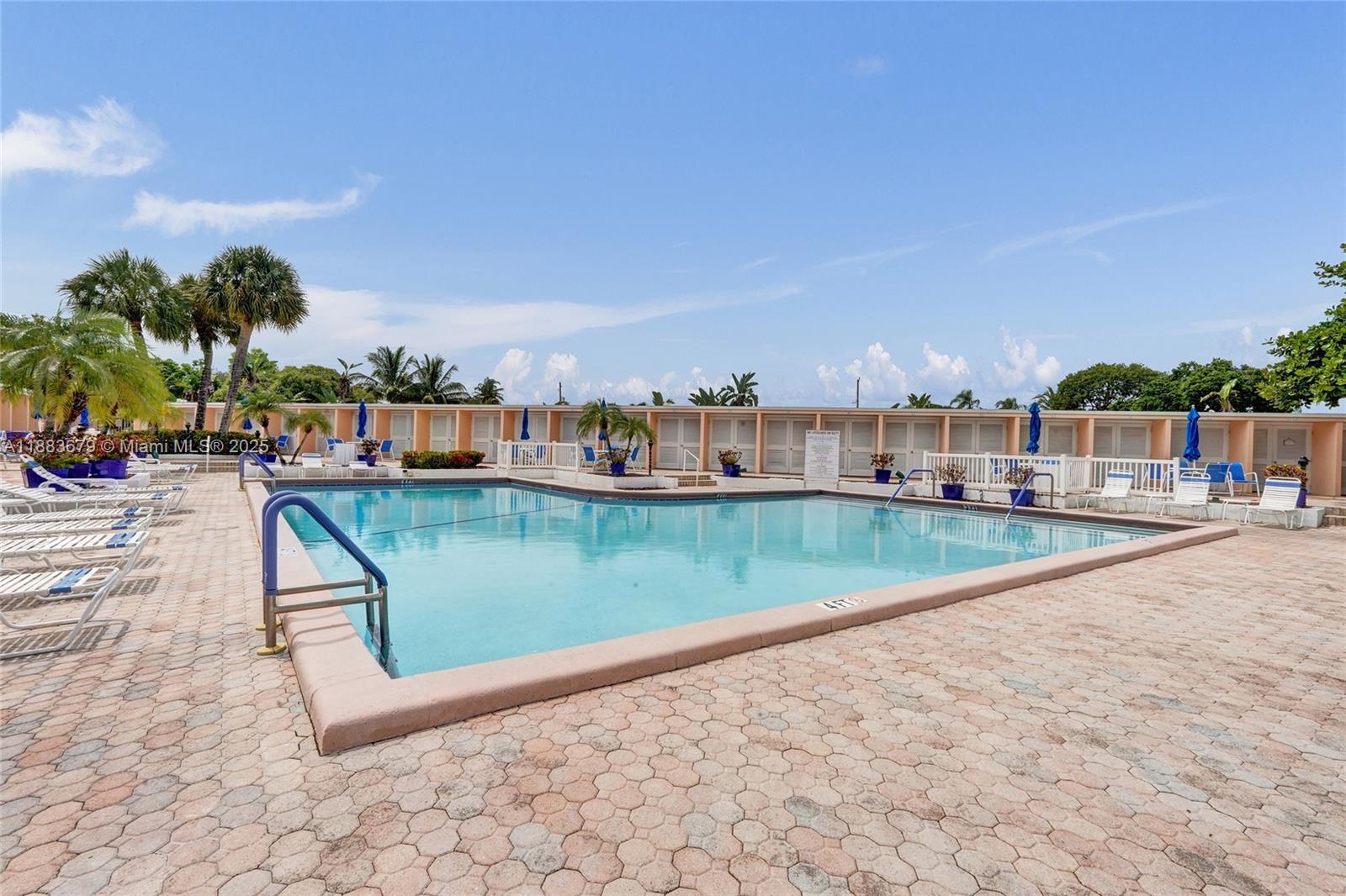 2181 Northeast 67th Street, Unit 622 Fort Lauderdale, FL 33308 - Photo 18 of 28 a view of swimming pool with outdoor seating and lake view