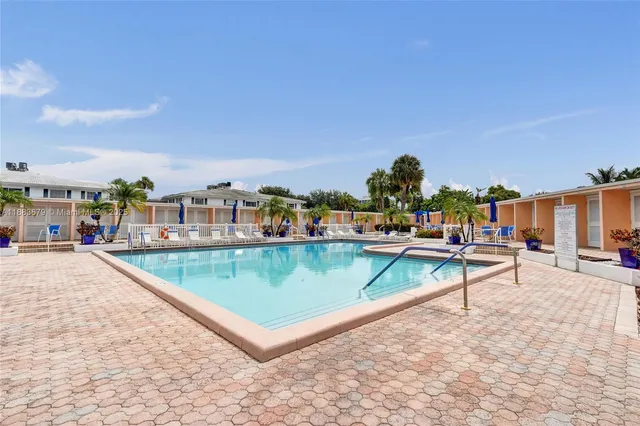 a view of a swimming pool with a lounge chair