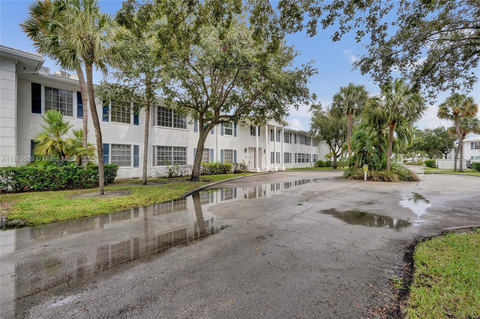 2181 Northeast 67th Street, Unit 622 Fort Lauderdale, FL 33308 - Photo 24 of 28 a view of a house with a yard and tree s