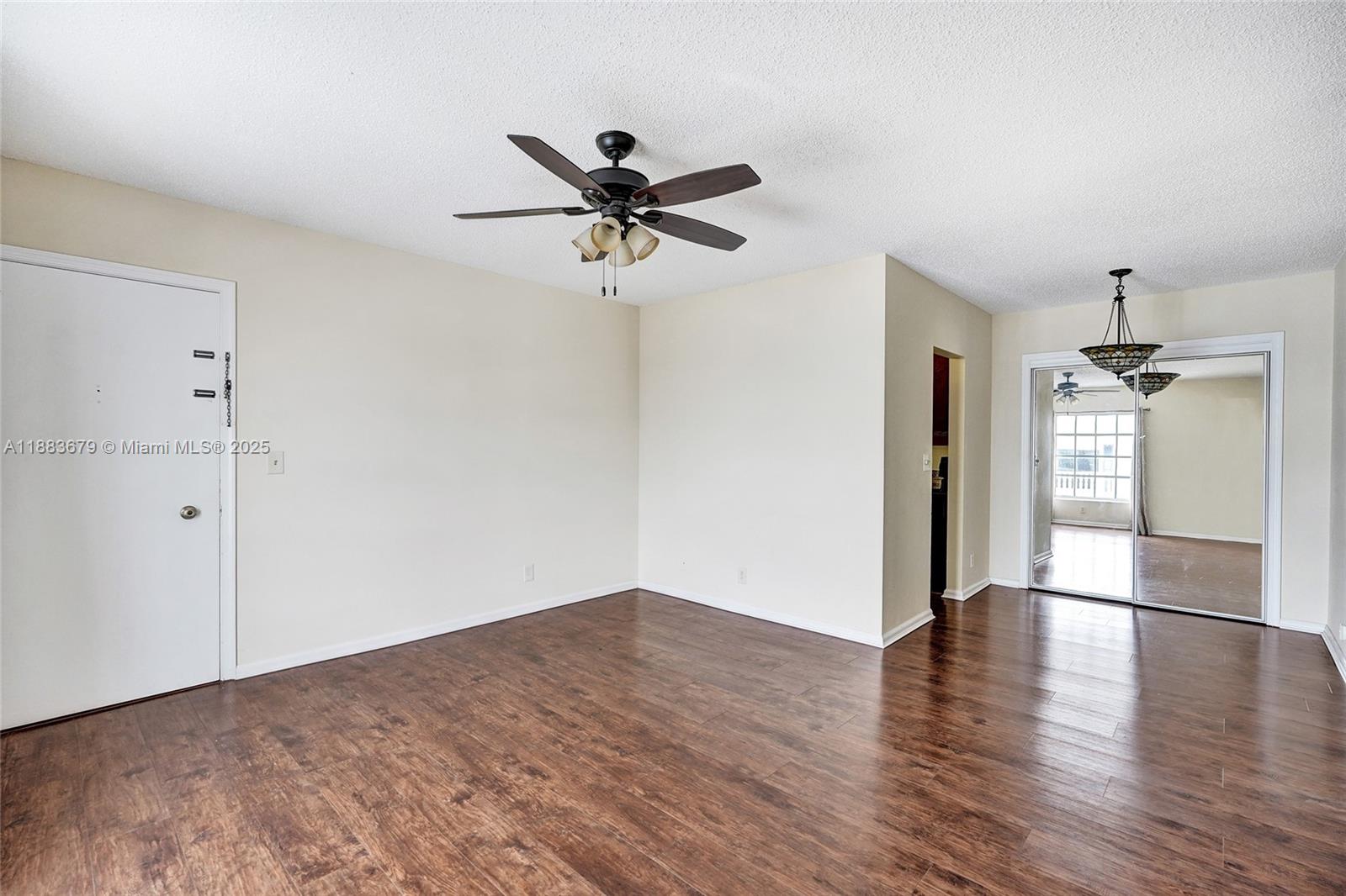 2181 Northeast 67th Street, Unit 622 Fort Lauderdale, FL 33308 - Photo 6 of 28 a view of a livingroom with wooden floor and a ceiling fan