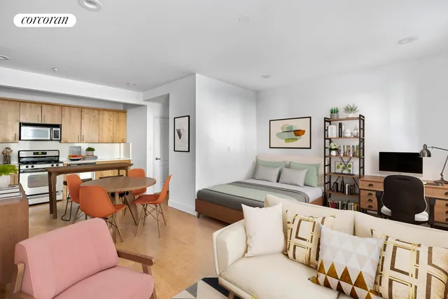 a bedroom with a bed a couch and a window