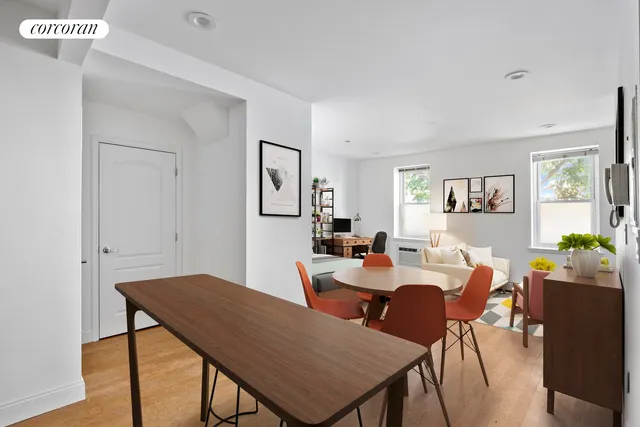 a kitchen with stainless steel appliances a stove a sink cabinets and a dining table