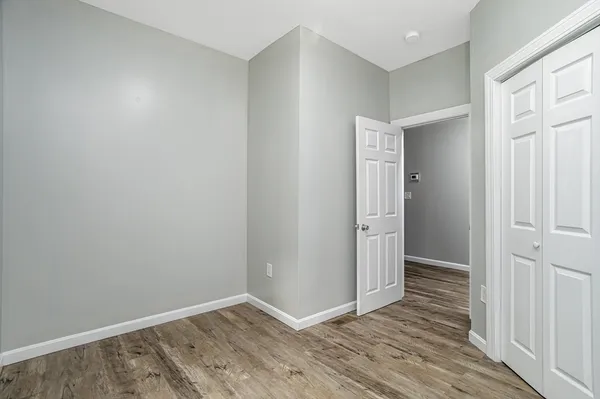 an empty room with wooden floor