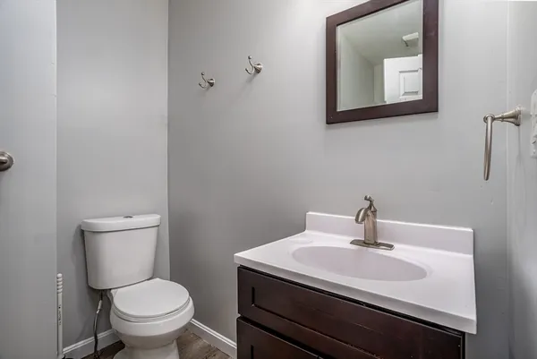 a bathroom with a toilet sink and mirror