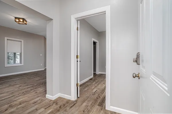 a view of a hallway with wooden floor