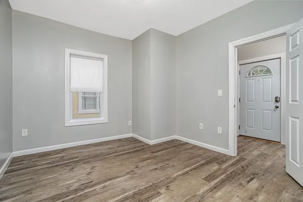 a view of a room with wooden floor and closet