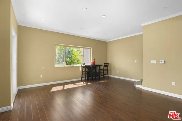 an empty room with furniture and a window