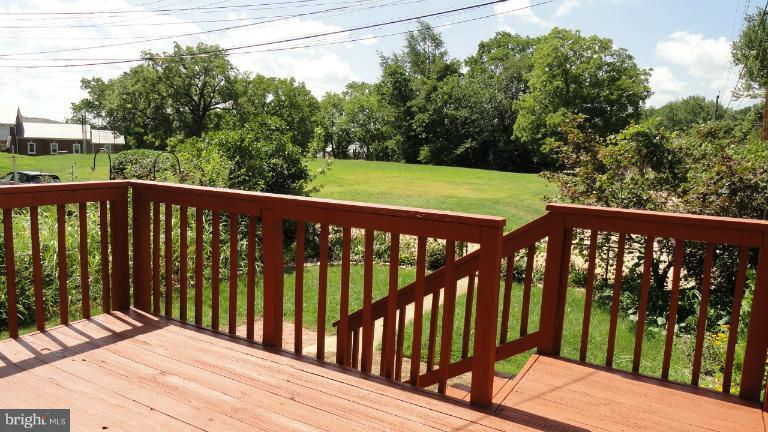 428 Academy Road Baltimore, MD 21228 - Photo 22 of 30 a wooden deck with trees in front of it