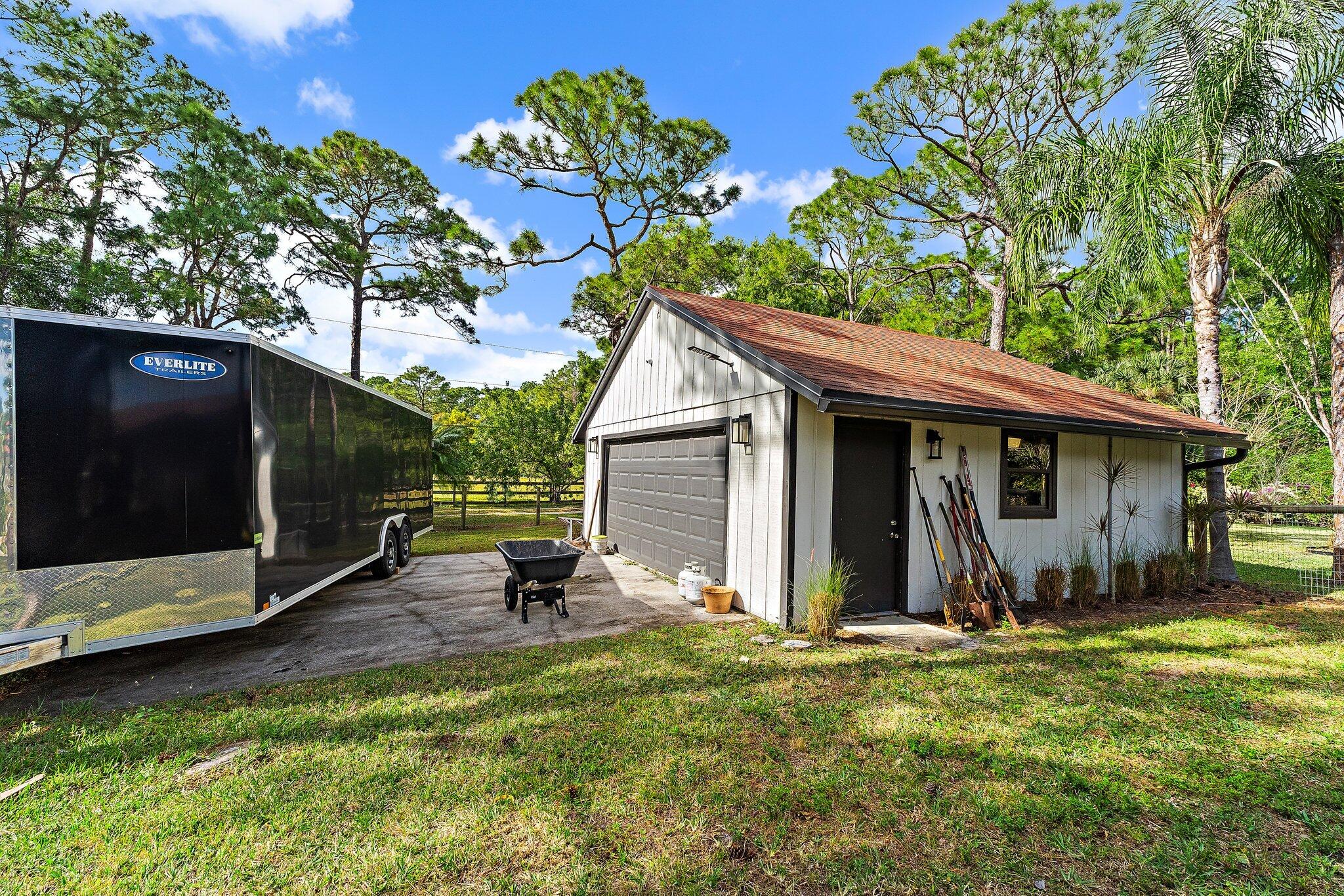 11845 165th Road North Jupiter, FL 33478 - Photo 12 of 68 a backyard of a house with barbeque oven table and chairs