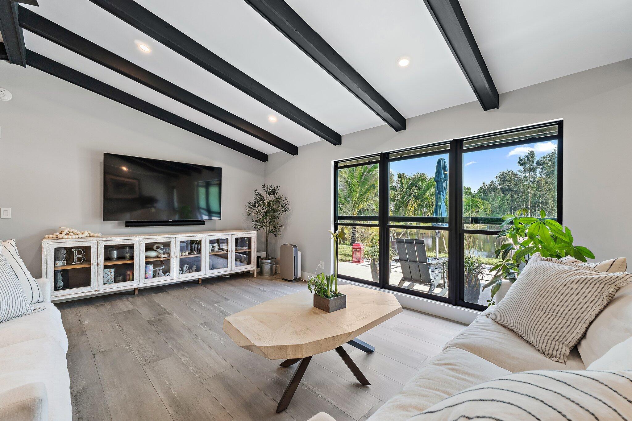11845 165th Road North Jupiter, FL 33478 - Photo 17 of 68 a living room with furniture and a flat screen tv