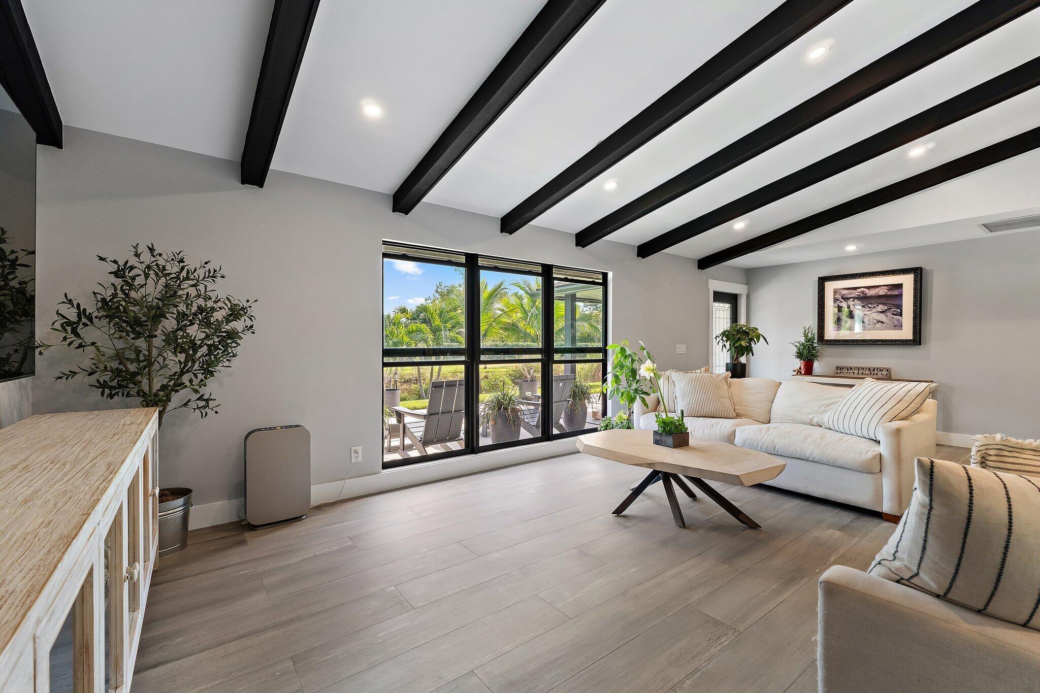 11845 165th Road North Jupiter, FL 33478 - Photo 18 of 68 a living room with furniture and a large window