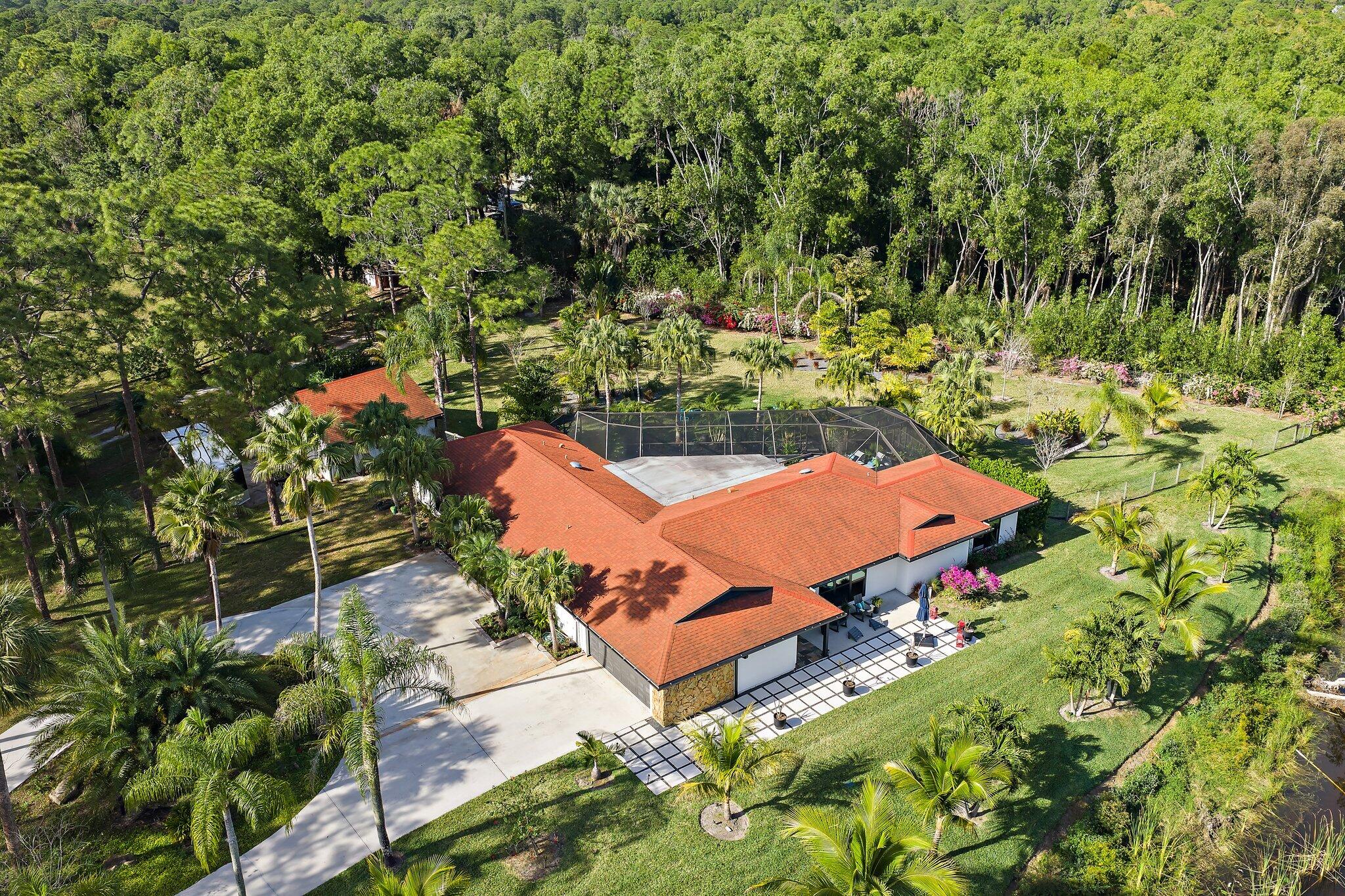 11845 165th Road North Jupiter, FL 33478 - Photo 2 of 68 an aerial view of a house with a yard