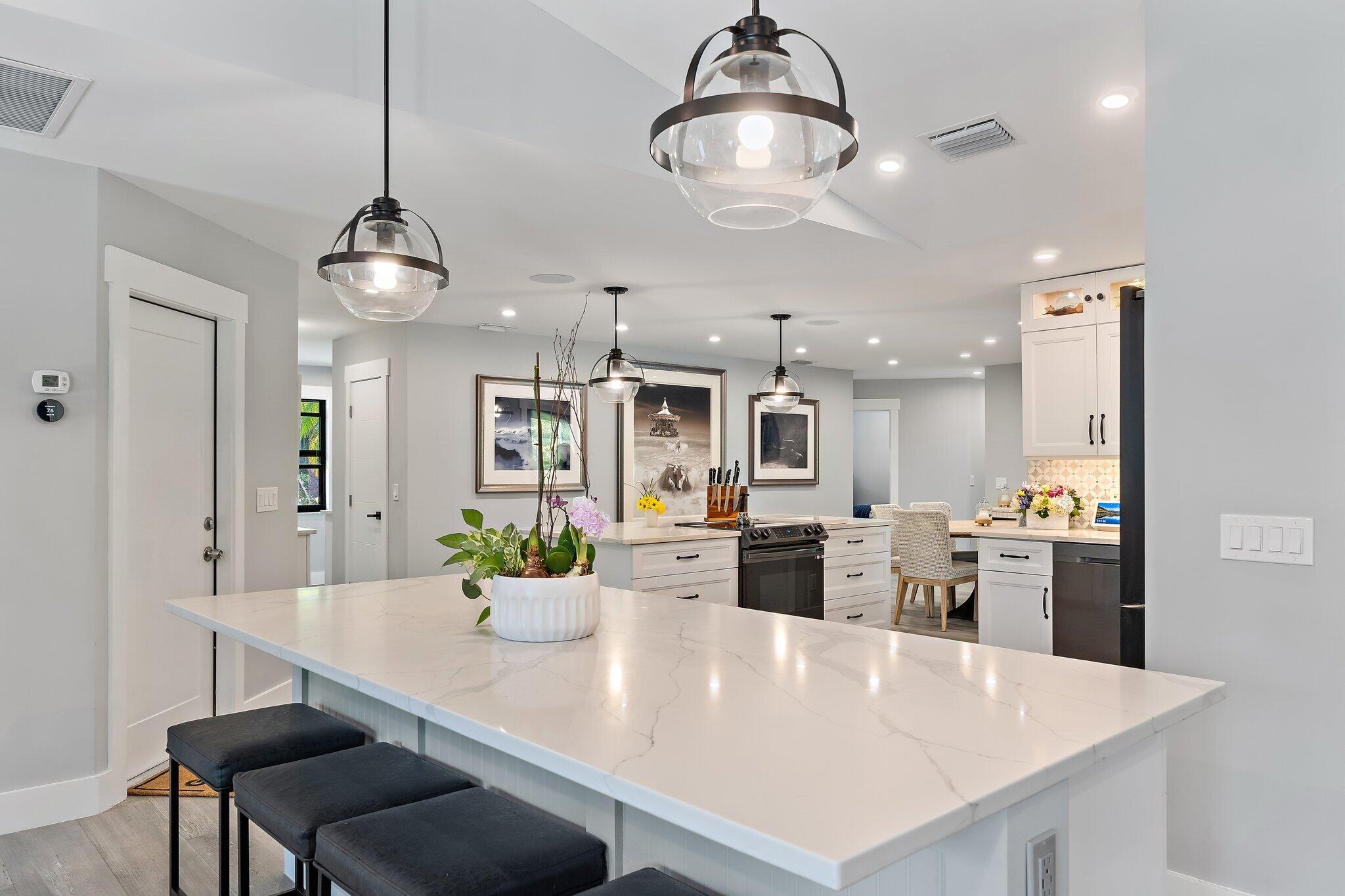 11845 165th Road North Jupiter, FL 33478 - Photo 23 of 68 a kitchen with a dining table and chairs