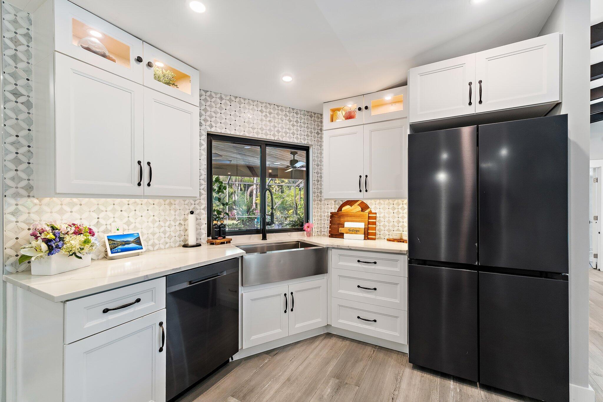 11845 165th Road North Jupiter, FL 33478 - Photo 25 of 68 a kitchen with a refrigerator and a sink
